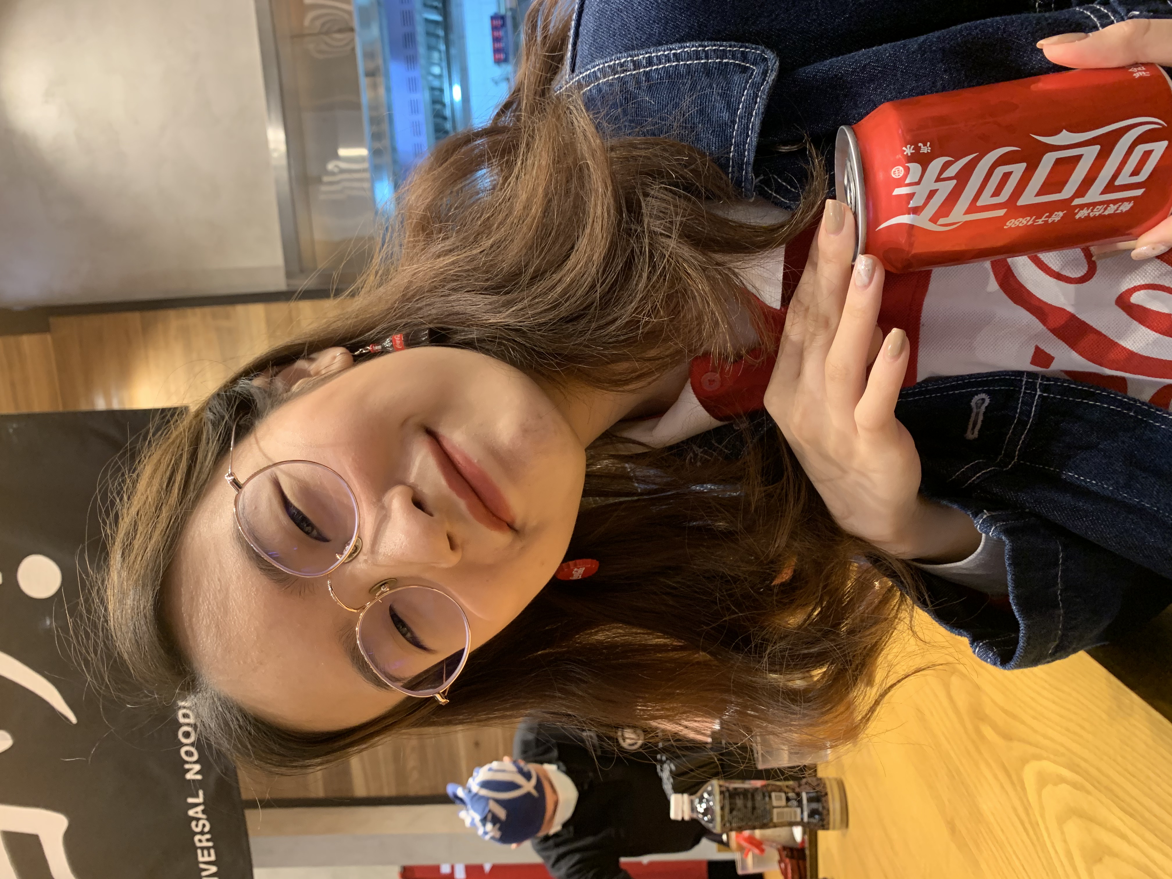 A picture of me holding a can of coke, while wearing a coke tshirt and coke earrings.