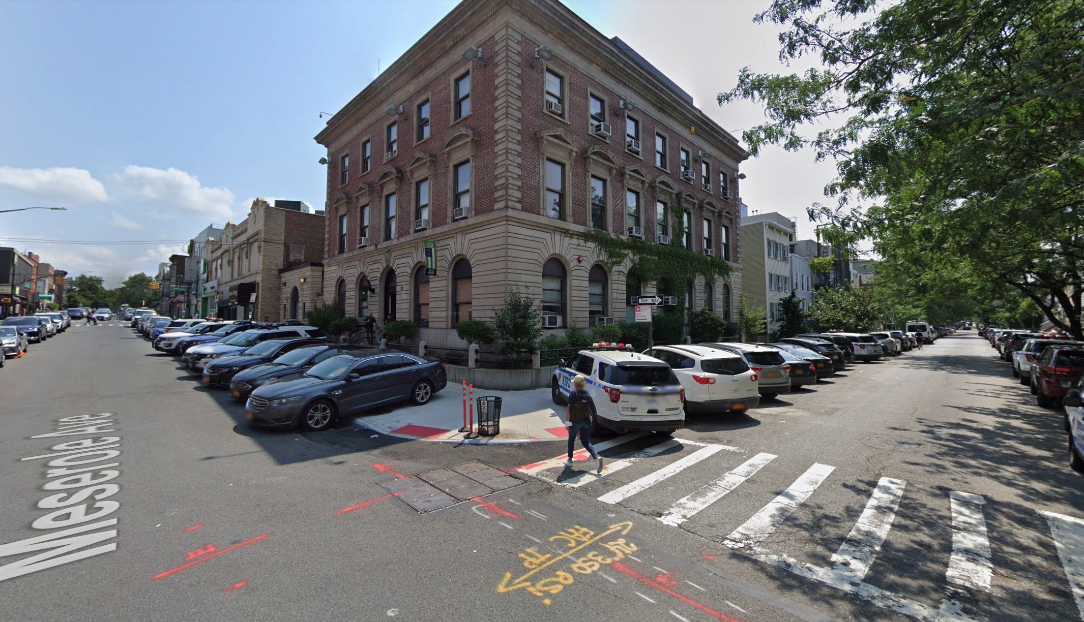 police ars parked on sidewalk in front of 94th precinct